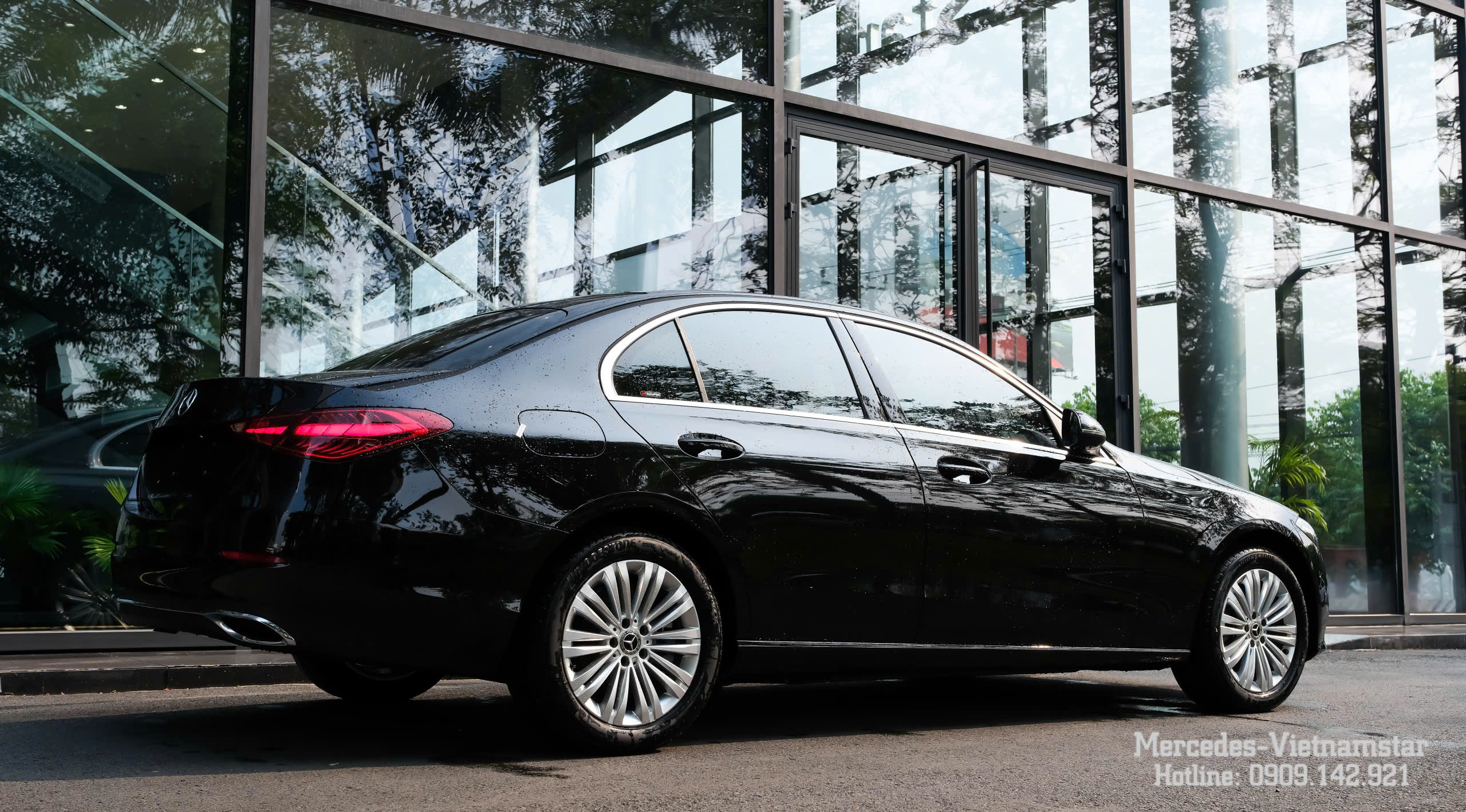 Xe Mercedes C200 màu đen đậu trước showroom hiện đại.